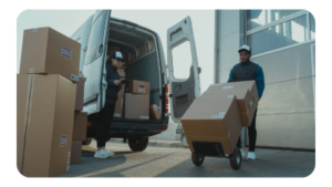 Two delivery men unloading packages from a van