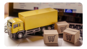 a toy truck with small packages on a laptop keyboard